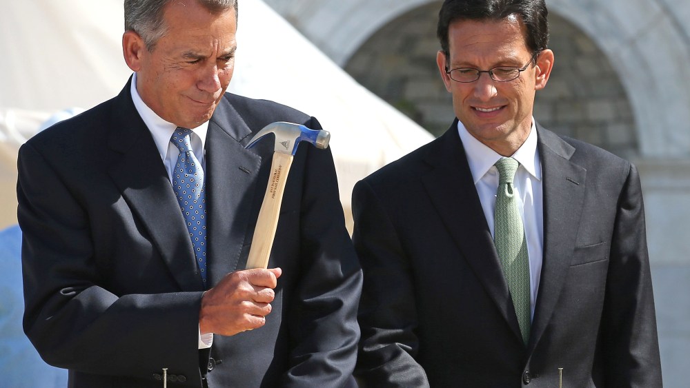 FILE PHOTO:  Speaker of the House John Boehner (R-OH) (L) wields his hammer with House Majority Leader Eric Cantor (R-VA) before the "First Nail" ceremony, signifying the start of construction of the 2013 Inaugural Platform on the West Front of the U.S...
