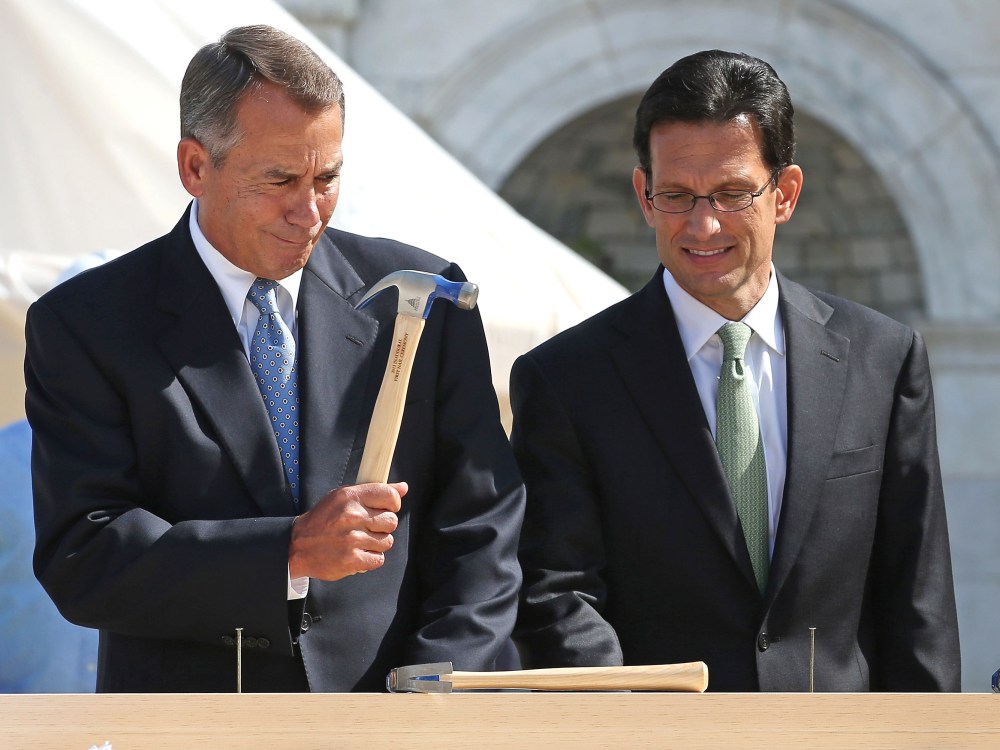 FILE PHOTO:  Speaker of the House John Boehner (R-OH) (L) wields his hammer with House Majority Leader Eric Cantor (R-VA) before the "First Nail" ceremony, signifying the start of construction of the 2013 Inaugural Platform on the West Front of the U.S...