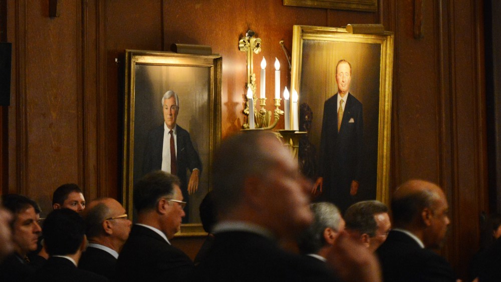 Potential donors listen as Republican presidential candidate Mitt Romney attends a fundraiser