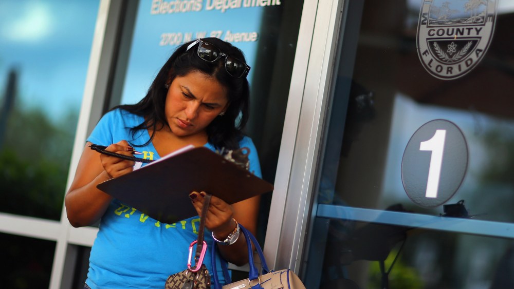 Ereyda Monge fills out her voter registration form at the Miami-Dade Elections Department in Florida.