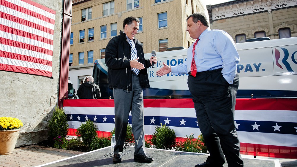 Mitt Romney shakes hands with Chris Christie as they talk with supporters at Buns Bakery and Restaurant in Delaware, Ohio, Oct. 10, 2012.