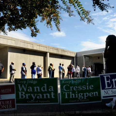 Campaign signs line the walk as people wait in line to vote in Wilson, North Carolina.