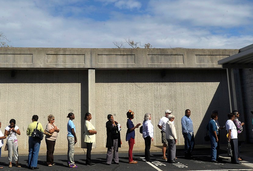 People wait in line to vote at the Board of Elections early voting site on October 18, 2012 in Wilson, North Carolina.