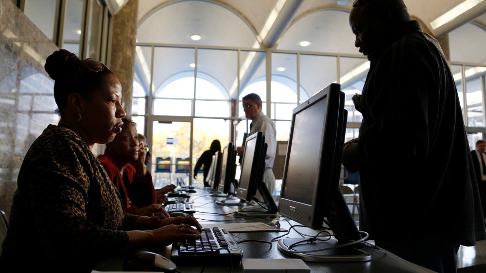 Poll workers help residents during early voting at the Milwaukee Municipal Building Oct. 22, 2012 in Milwaukee, Wisc. (Darren Hauck/Getty)