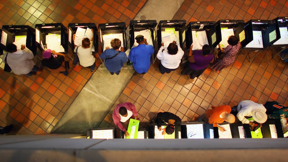 Early voters fill out their ballots as they cast their vote in the presidential election on the first day of early voting, Oct. 27, 2012 in Miami, Fla.