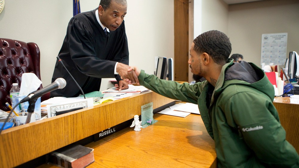 Judge Robert Russell, creator of the Buffalo Veterans Treatment Court, shakes hands with veteran Justin Smith who has succeeded in his court, on Oct. 23, 2012.