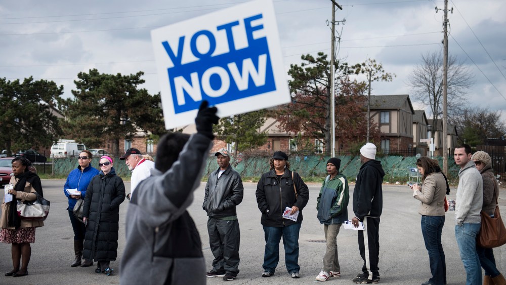 People wait in line for early voting in the parking lot of the Northland Park Center on November 4, 2012 in Columbus, Ohio.