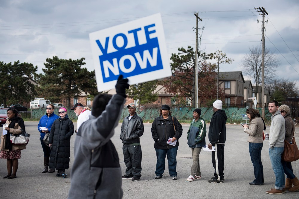 People wait in line for early voting in the parking lot of the Northland Park Center on November 4, 2012 in Columbus, Ohio.