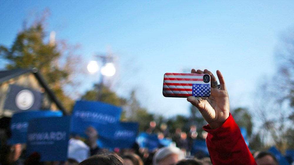 A cell phone with an American flag cover is held up during a rally  in Sterling, Virginia.