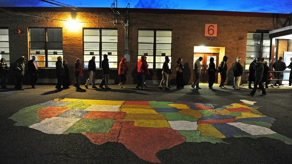 People enter Washington Mill Elementary School to cast their vote in the U.S. presidential race, Nov. 6, 2012, in Alexandria, Va.