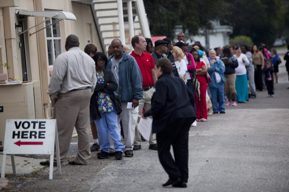 Lines of voters wait to cast their ballots as the polls open on November 6, 2012 in St. Petersburg, Florida.