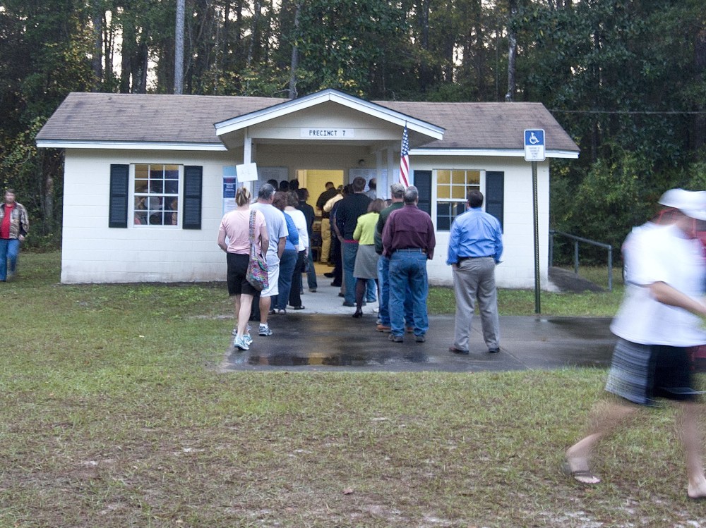 Voters leave the polls just after dawn as other voters queue to place their ballots at the tiny County Polling House in the Ivan Community of Wakulla County on November 6, 2012 in Crawfordville, Florida. The swing state of Florida is recognised to be...