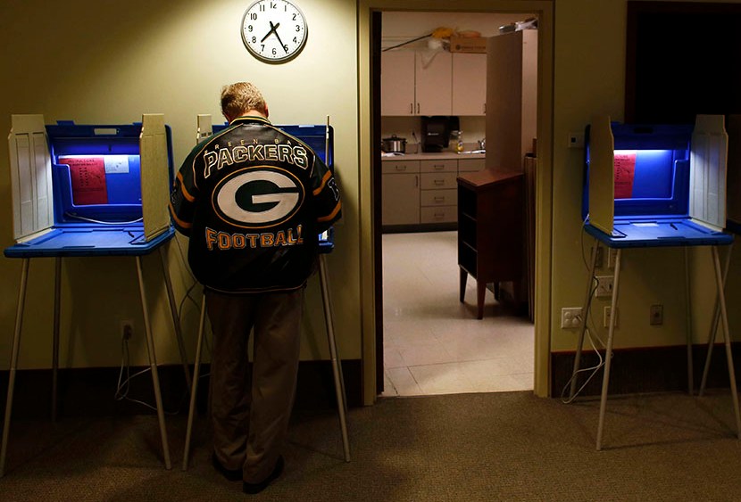 Voters cast their vote in the Presidential elections on November, 6, 2012 in Janesville Wisconsin. (Photo by Darren Hauck/Getty)