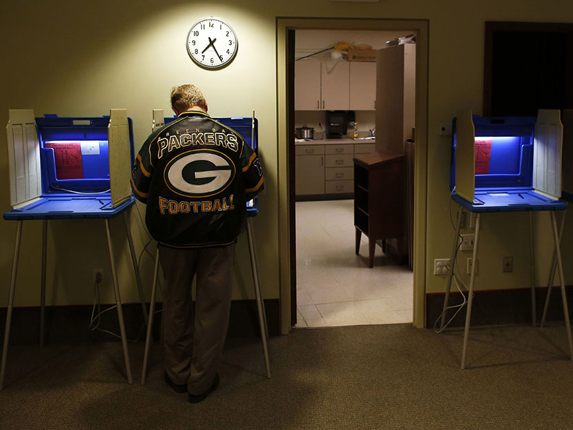 Voters cast their vote in the Presidential elections on November, 6, 2012 in Janesville Wisconsin. (Photo by Darren Hauck/Getty)