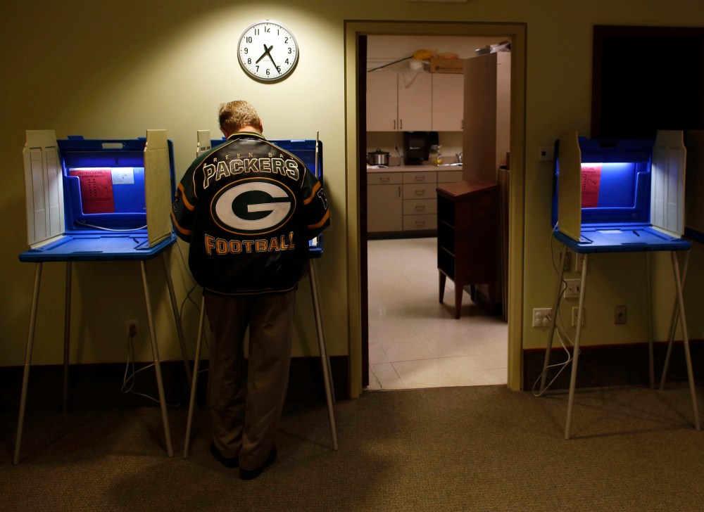 Voters cast their vote in the Presidential elections on November, 6, 2012 in Janesville, Wisconsin.