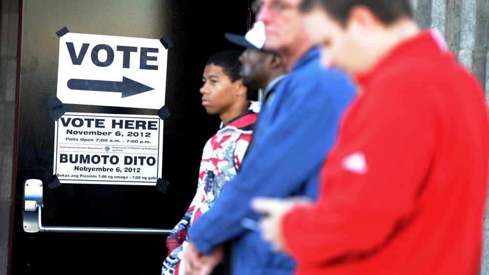 People wait in line to vote before the polling station at the Clark County Fire Training Center opens on Nov. 6, 2012 in Las Vegas, Nev.