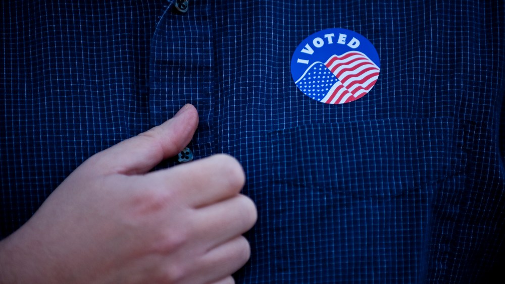 Rev. Chase Peeples displays his "I Voted" sticker after voting in Kansas City, Missouri, Nov. 6, 2012.