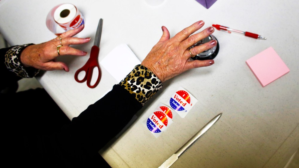 A volunteer poll worker rings a bell to count votes at a polling station on November 6, 2012 in Richmond, Wisconsin.
