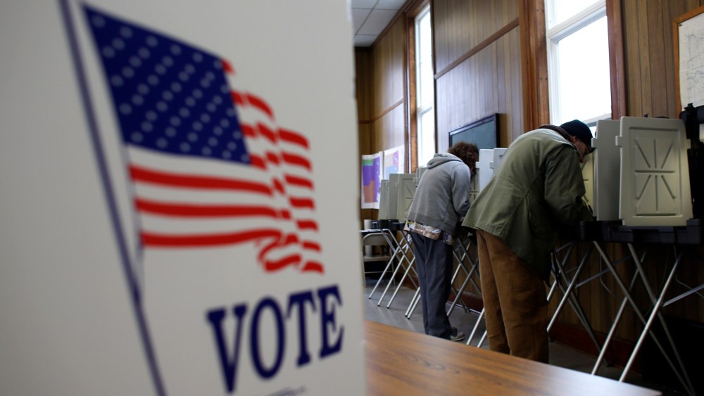 A man and woman cast their vote at a polling station on November 6, 2012 in Sugar Creek, Wisconsin.