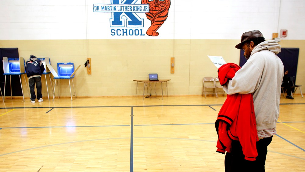A man goes over his ballot at the Martin Luther King elementary school on November 6, 2012 in Milwaukee, Wisconsin.