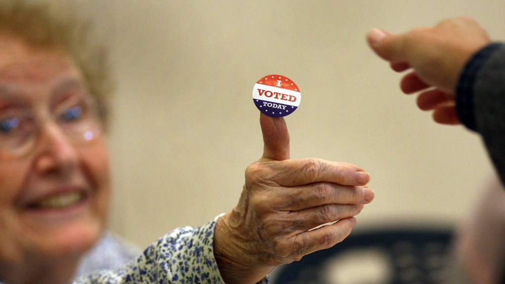 At the Beech Street Center in Belmont, poll worker Rosemary Good handed out "I voted" stickers on Election Day, Nov. 6, 2012.