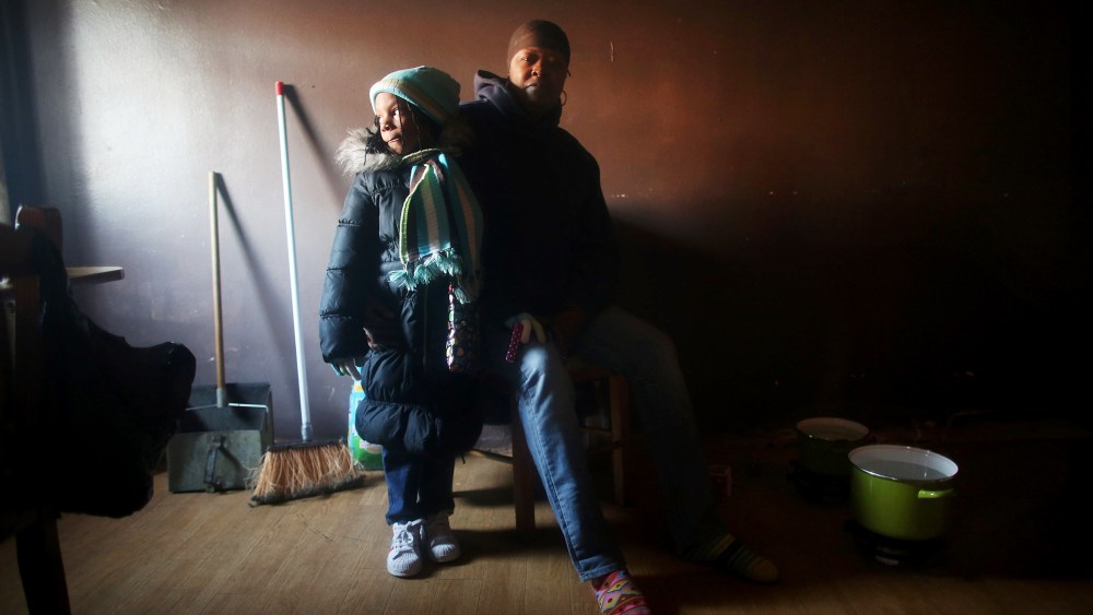 Mac Baker poses with her niece in her unheated apartment in the Ocean Bay public housing projects, Nov. 9, 2012.