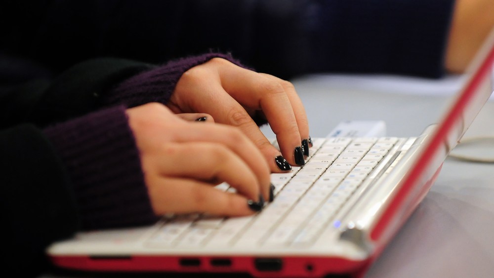 A woman types on her laptop. (Photo by Frederic J. Brown/AFP/Getty)