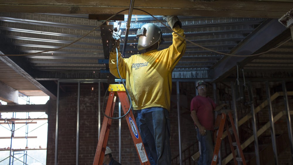 A welder works on a ceiling structure at new Fraunhofer Building Technology Showcase October 2, 2012.