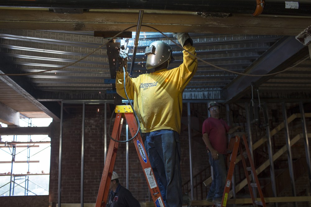 A welder works on a ceiling structure at new Fraunhofer Building Technology Showcase October 2, 2012.
