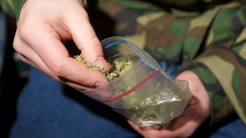 A Seattle resident takes marijuana from a plastic bag shortly after a law legalizing the recreational use of marijuana took effect on Dec. 6, 2012 in Seattle, Washington.