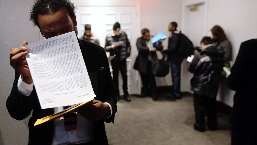 Applicants wait in line to meet potential employers at the Diversity Job Fair on Dec. 6, 2012 in New York, NY.