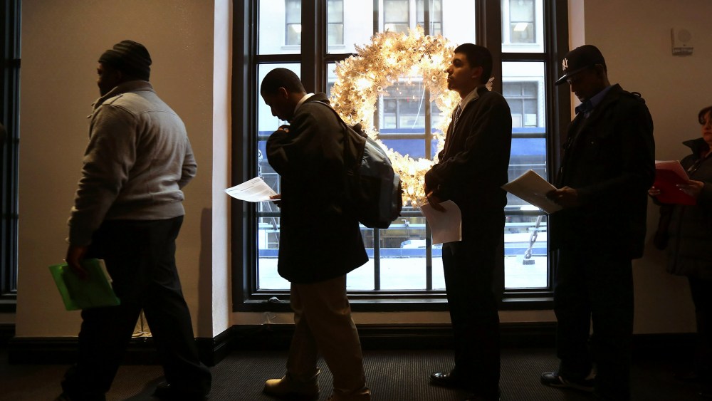Applicants line up to meet potential employers at the Diversity Job Fair, Dec. 6, 2012, in New York, N.Y.