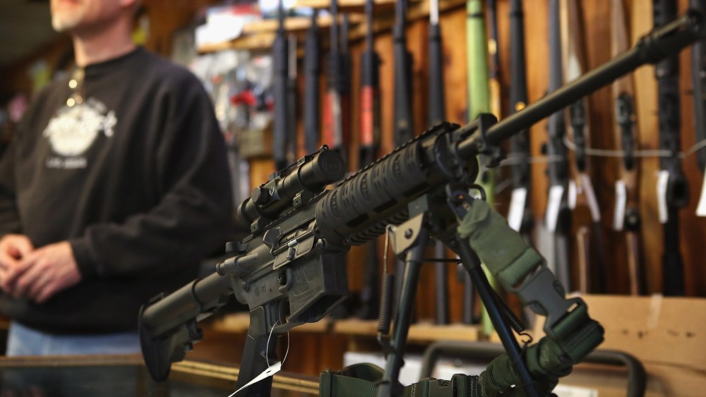 File Photo: An AR-15 style rifle sits on the counter by Craig Marshall as he assists a customer at Freddie Bear Sports sporting goods store on December 17, 2012 in Tinley Park, Illinois.  Americans purchased a record number of guns in 2012 and gun...