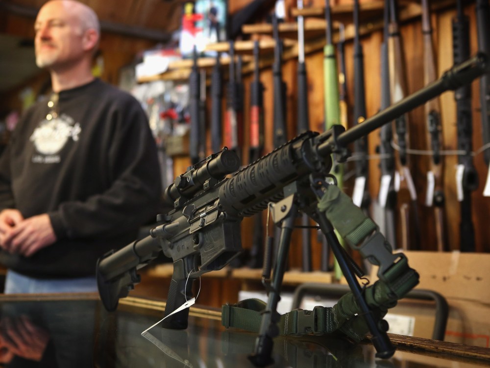 File Photo: An AR-15 style rifle sits on the counter by Craig Marshall as he assists a customer at Freddie Bear Sports sporting goods store on December 17, 2012 in Tinley Park, Illinois.  Americans purchased a record number of guns in 2012 and gun...