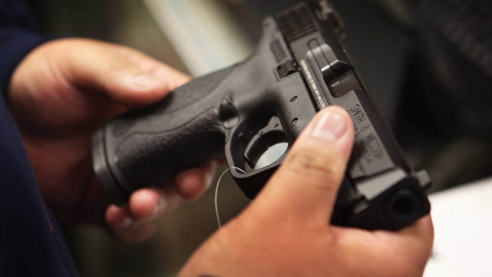 A customer shops for a pistol at a sporting goods store on Dec. 17, 2012 in Tinley Park, Ill.