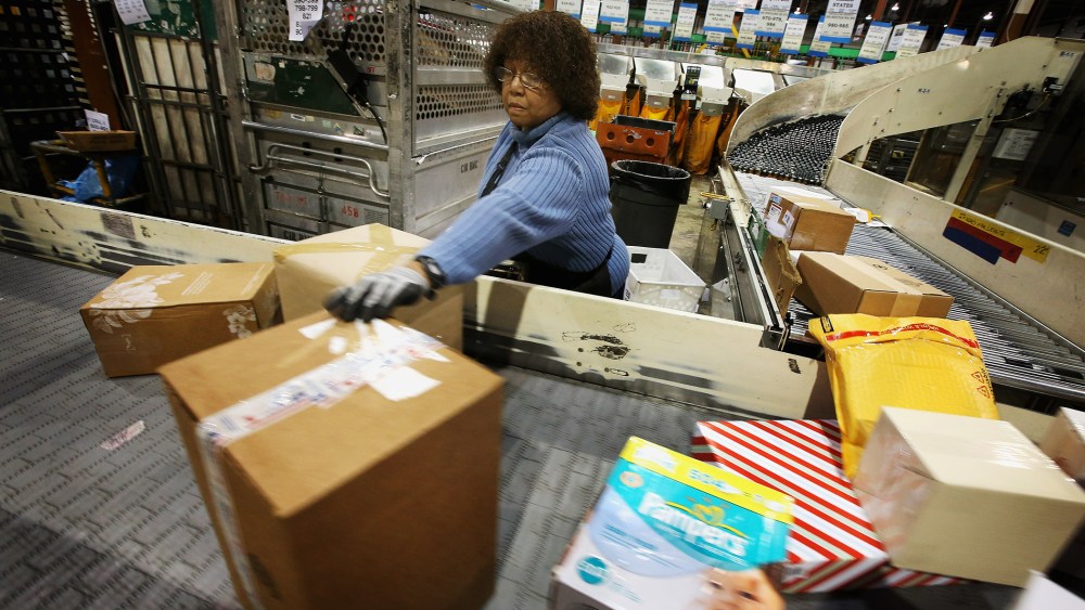 Bobbi Crump moves mail on a conveyor, December 17, 2012 in Elk Grove Village, Illinois.