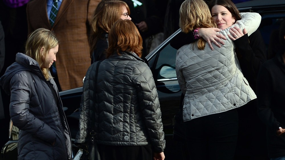 Krista (R) Rekos, the mother of Jessica Rekos, 6, is comforted after a funeral service at Saint Rose of Lima Church on Dec. 18, 2012 in Newtown, Conn.