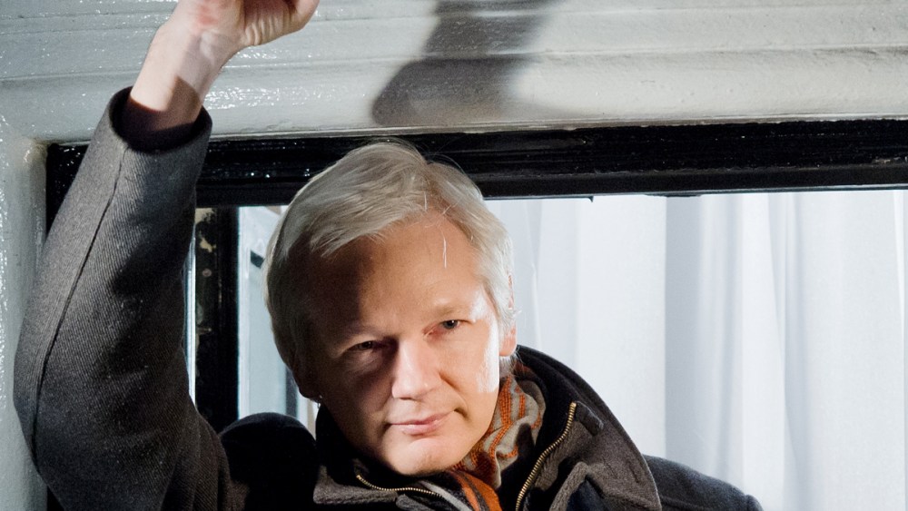 File Photo: Wikileaks founder Julian Assange at the window of the Ecuadorian embassy in Knightsbridge, west London on December 20, 2012. (Photo by Leon Neal/AFP/Getty Images, File)