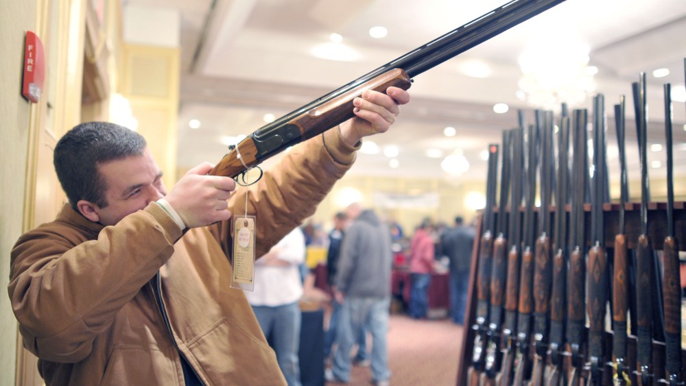 Collin McCarthy of Monroe, Connecticut, looks at a shotgun during the 8th Annual East Coast Fine Arms Show in Stamford, Connecticut January 6, 2013.  (Photo by Timothy A. Clary/AFP/Getty Images)