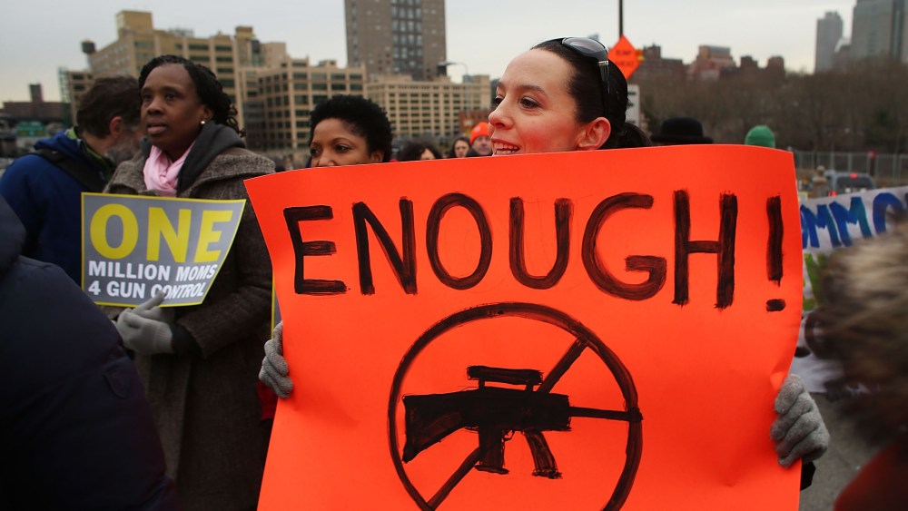 Participants with One Million Moms for Gun Control, a gun control group formed in the wake of last month's massacre at a Newtown, Connecticut elementary school, attend a rally and march across the Brooklyn Bridge on January 21, 2013 in New York City. ...