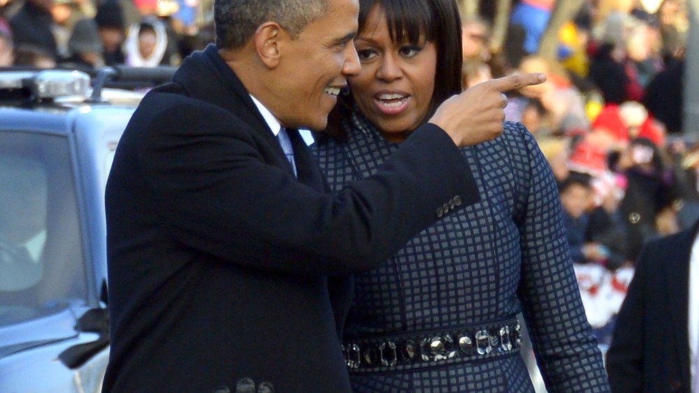 US President Barack Obama and First Lady Michelle Obama walk along Pennsylvania Avenue during the parade following Obama's second inauguration as the 44th US president on January 21, 2013 in Washington, DC. (Photo by Jim Watson/AFP/Getty Images)