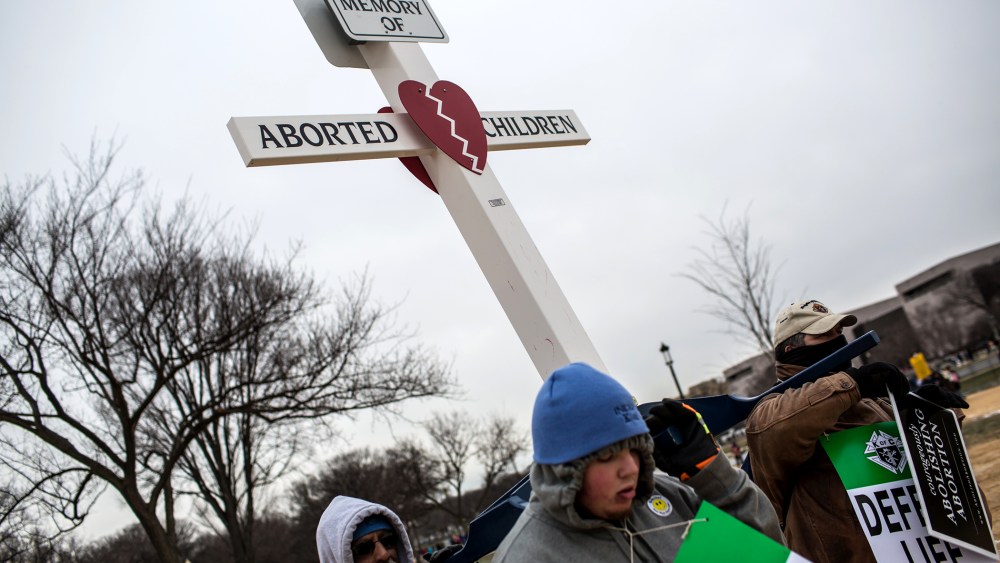 Anti-abortion protesters carry a cross at the March for Life on Jan. 25, 2013 in Washington, DC.
