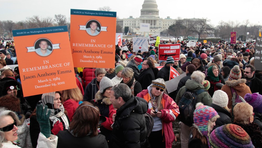 Thousands of people participate in the March on Washington for Gun Control on January 26, 2013 in Washington, following last month's school shooting in Newtown, Connecticut.  (Photo by Yuri Gripas/AFP/Getty Images)