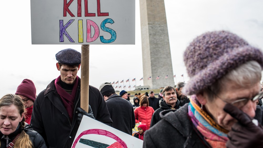 Cori Lynn Campbell, her husband Erik Singer, both of Maplewood, New Jersey, and Martha Nichols, of Vienna Virginia, participate in a rally on the National Mall for stricter gun control laws on January 26, 2013 in Washington, DC. Demonstrators included...