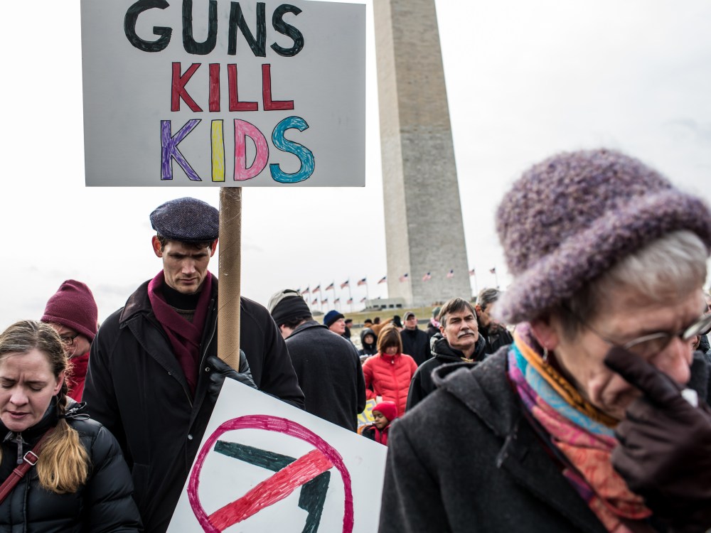 Cori Lynn Campbell, her husband Erik Singer, both of Maplewood, New Jersey, and Martha Nichols, of Vienna Virginia, participate in a rally on the National Mall for stricter gun control laws on January 26, 2013 in Washington, DC. Demonstrators included...