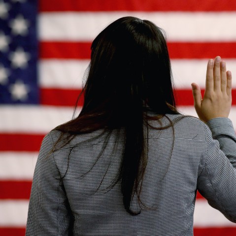 An woman takes the oath of allegiance during a naturalization ceremony at the at district office of the U.S. Citizenship and Immigration Services (USCIS) on January 28, 2013 in Newark, New Jersey. Some 38,000 immigrants became U.S. citizens at the...