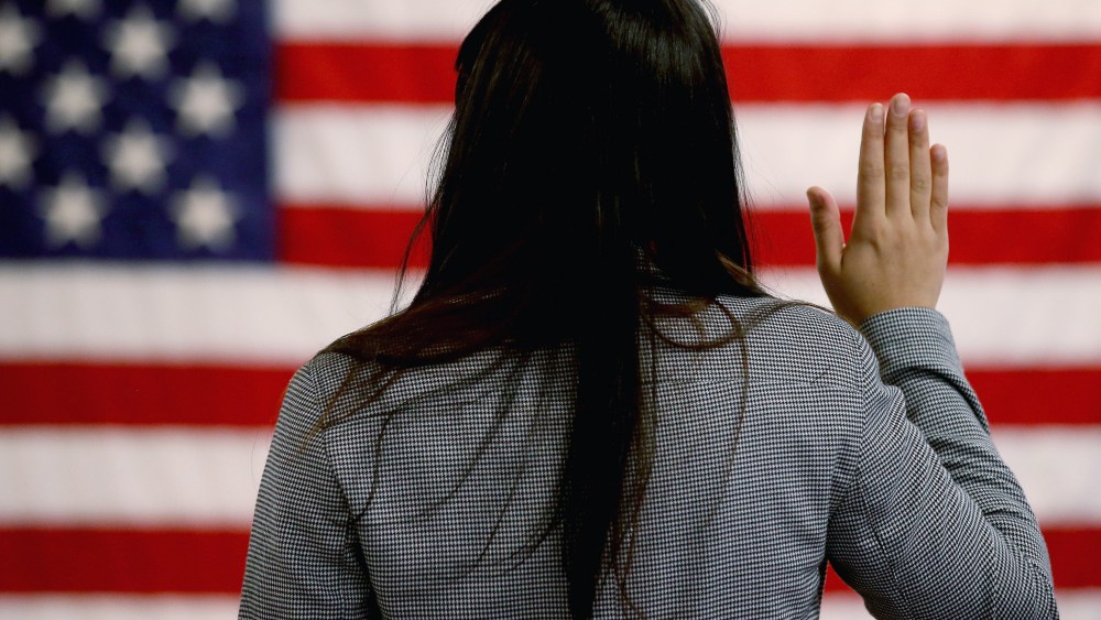 An woman takes the oath of allegiance during a naturalization ceremony at the at district office of the U.S. Citizenship and Immigration Services (USCIS) on January 28, 2013 in Newark, New Jersey. Some 38,000 immigrants became U.S. citizens at the...