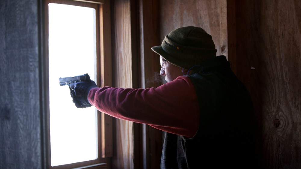 A man practices shooting his semi-automatic handgun at targets at the Ferry Brook Range, on January 26, 2013 in Keene, New Hampshire.