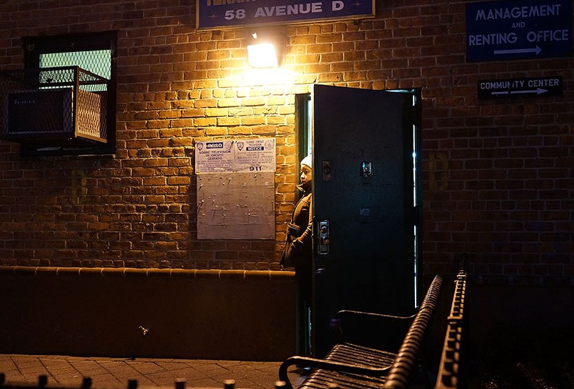 A woman looks out from the door of a housing project on the Lower East Side of Manhattan on January 31, 2013 in New York City.  (Photo by Spencer Platt/Getty Images)
