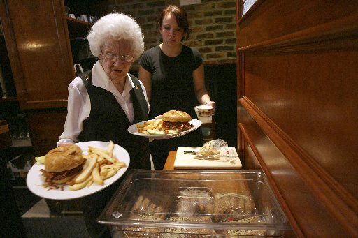 Rose Donaghey, 88, foreground, and Priscilla Adams work during the lunch hour at the Wicked Wolf restaurant in the East Tremont section of the Bronx, Wednesday, Oct. 15, 2008 in New York. (AP Photo/Mary Altaffer)